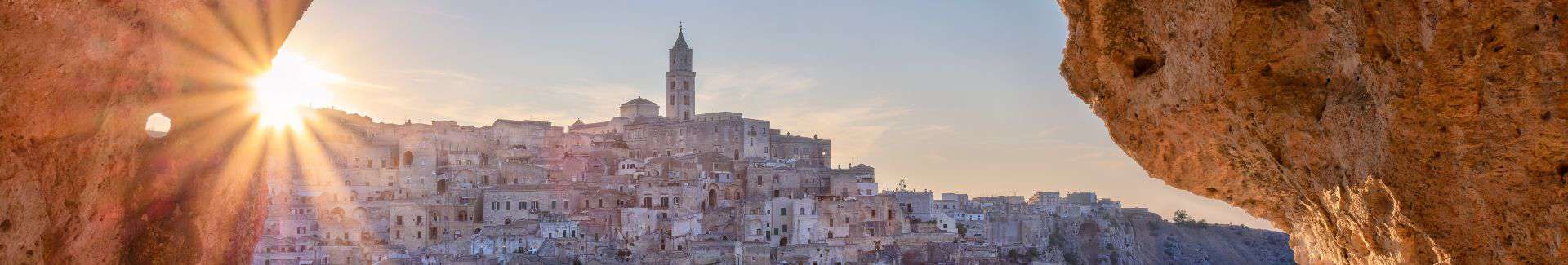 The city of Matera, Italy at sunrise as seen from a Sassi cave.