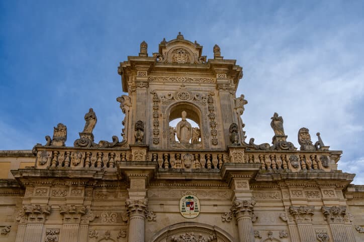 Close up of bishop statue atop Lecce cathedral.