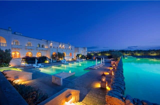The pool at Borgo Egnazia, lit up at dusk.